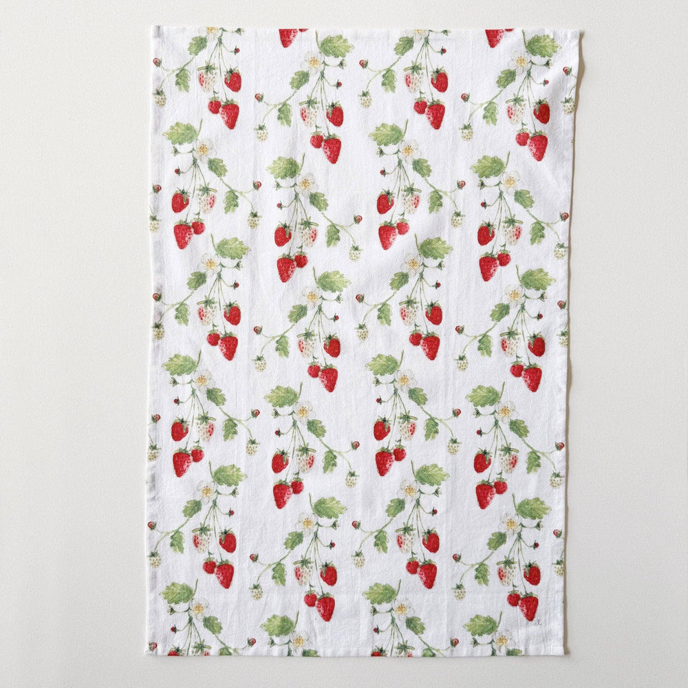 Kitchen towel laid flat to show repeated pattern of stems with strawberries.