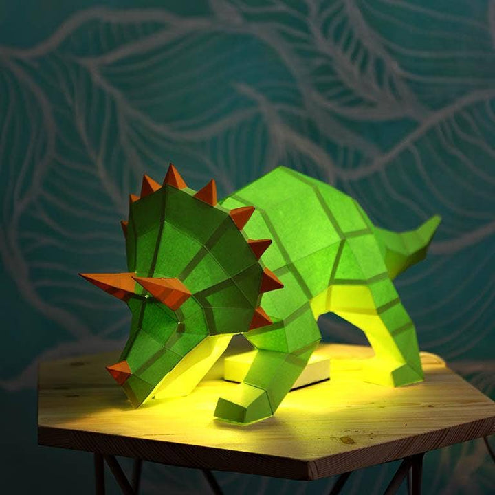 Origami green triceratops as a lamp, lit from within.