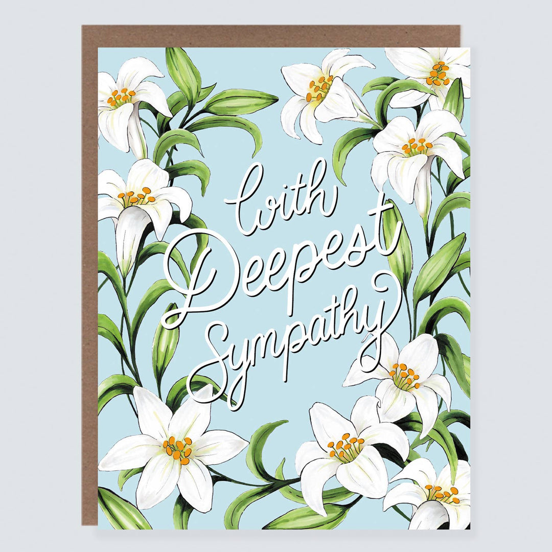 Nine white lilies with green leaves surround white text on blue cardstock.