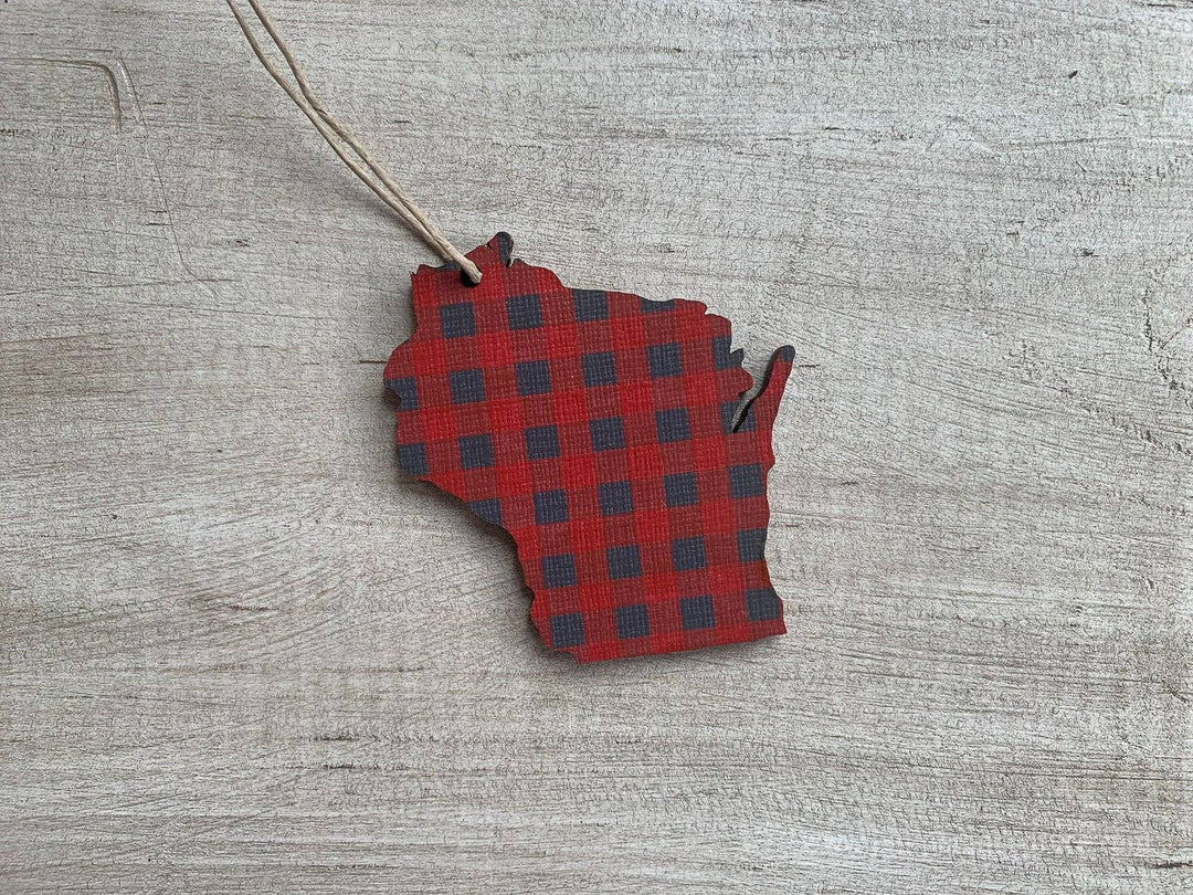 Ornament cut in the shape of the state of Wisconsin in red buffalo plaid and a hanging string.