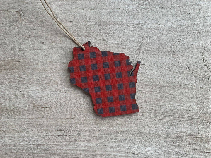 Ornament cut in the shape of the state of Wisconsin in red buffalo plaid and a hanging string.