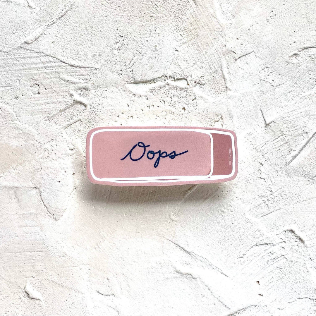 Sticker in the shape of a pink eraser with 'Oops' in script.