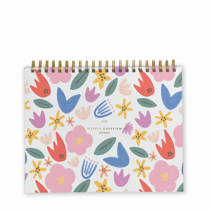 Cover of weekly planner with a pattern of multi-colored flowers and a gold spiral binding at top.