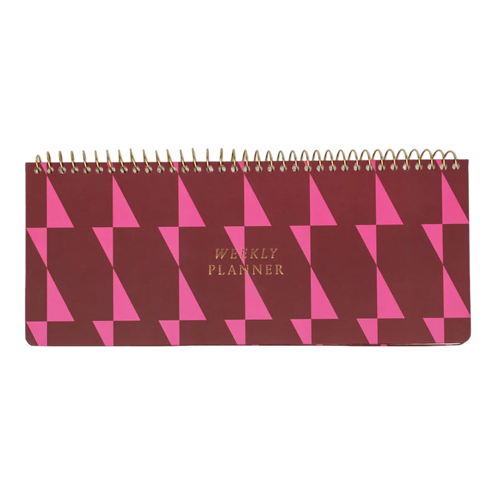 Planner with a light and dark pink geometric pattern, labeled 'Weekly Planner' with wire-o binding across the top.