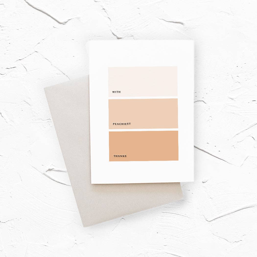 A minimalist art print card with three horizontal color blocks in shades of peach, labeled 'with', 'peachiest, and 'thanks', resting on a neutral gray envelope.