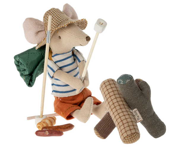 Hiker mouse with marshmallow on a stick in front of logs.