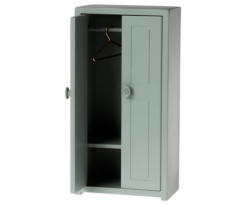 Tall green cabinet with one open door one hanger on the rod and a shelf near the bottom.