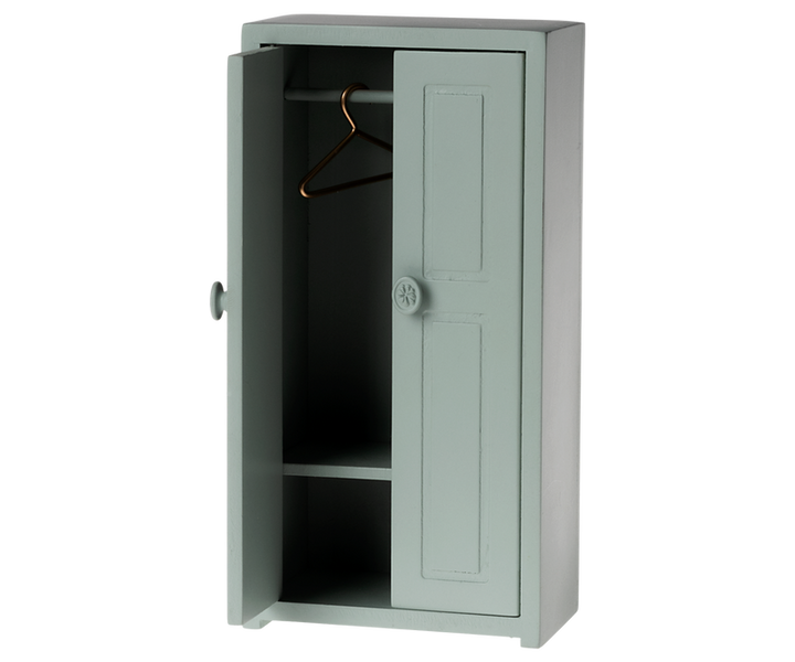 Tall green cabinet with one open door one hanger on the rod and a shelf near the bottom.