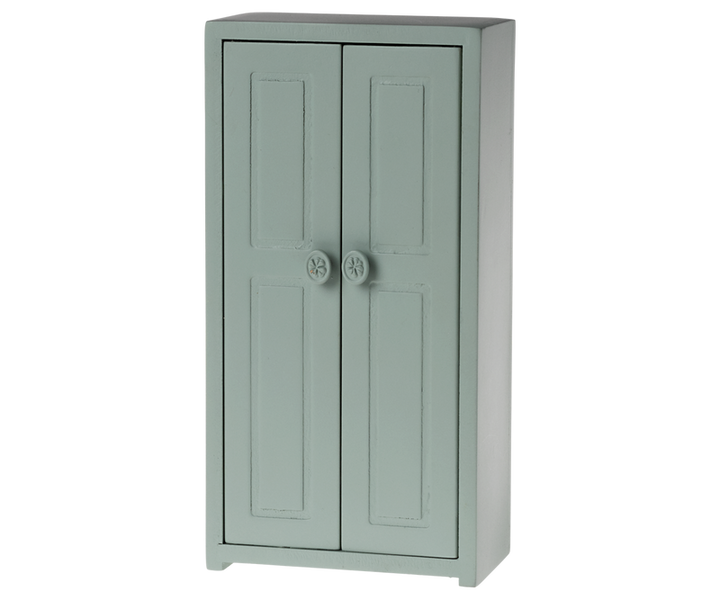 Tall green cabinet with two vertical doors .