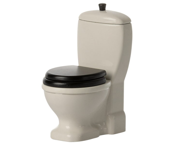 Off-white toilet with black seat and black handle pull to flush.