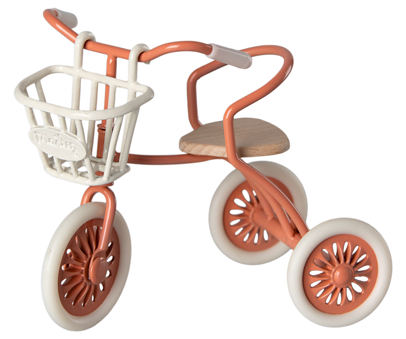 White metal basket on an orange Maileg tricycle.