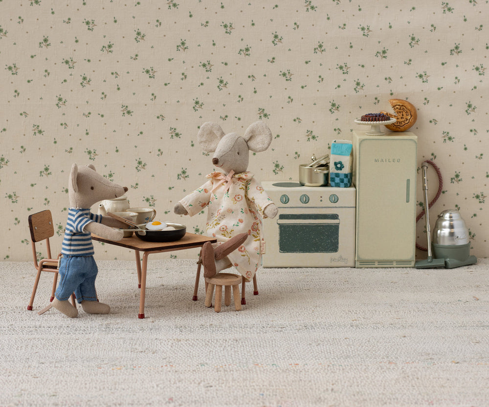 Table and chairs in a mouse kitchen scene.