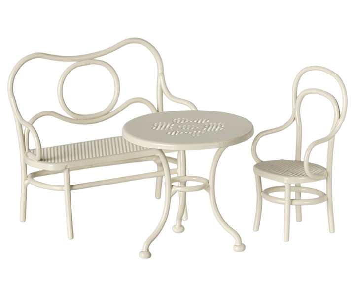 Off-white round café table, bench and chair in classic style with rounded arms and back.