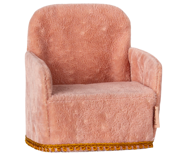Pink plush armchair with gold trim at bototm.