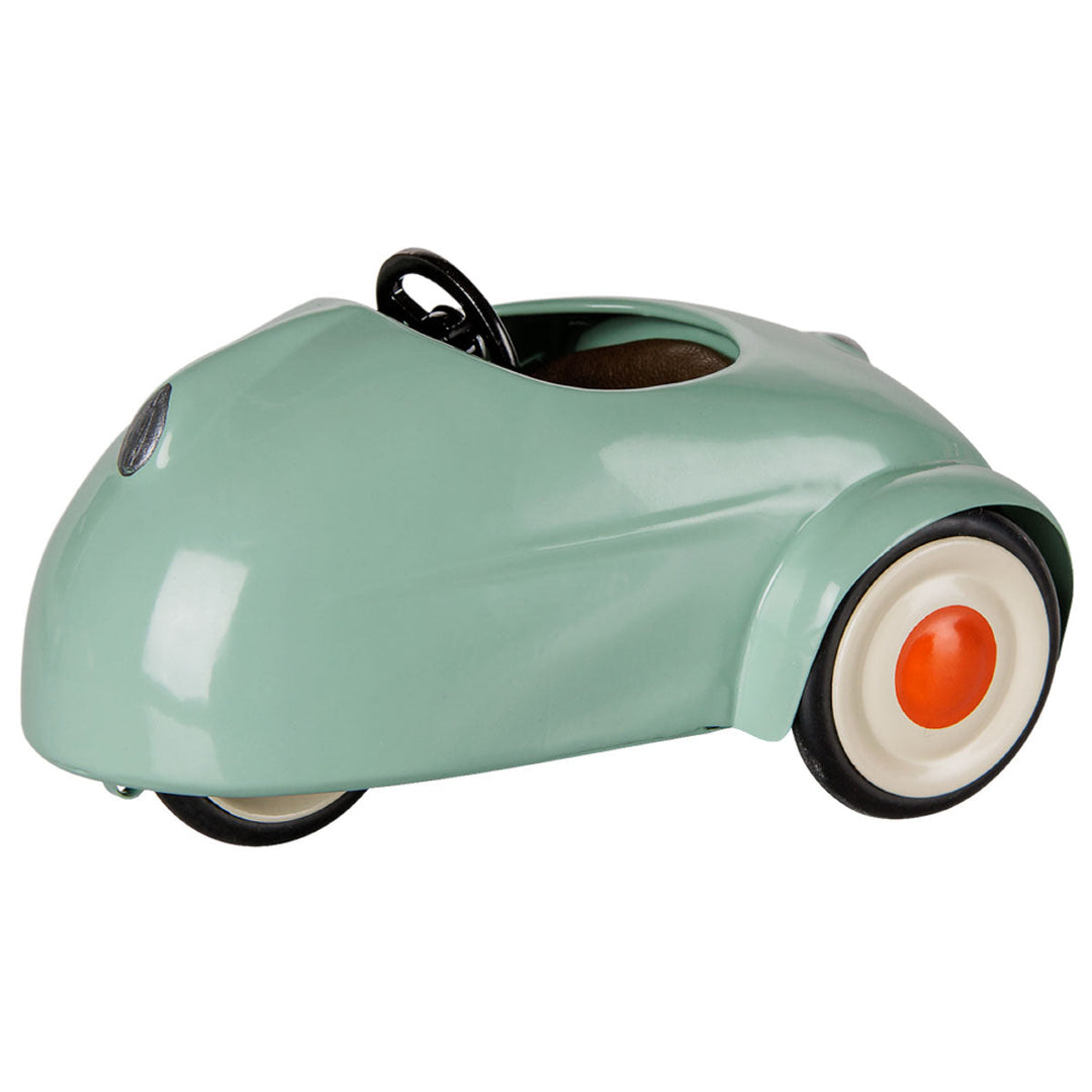 Light mint mouse car with white wheels with red hub cap. 