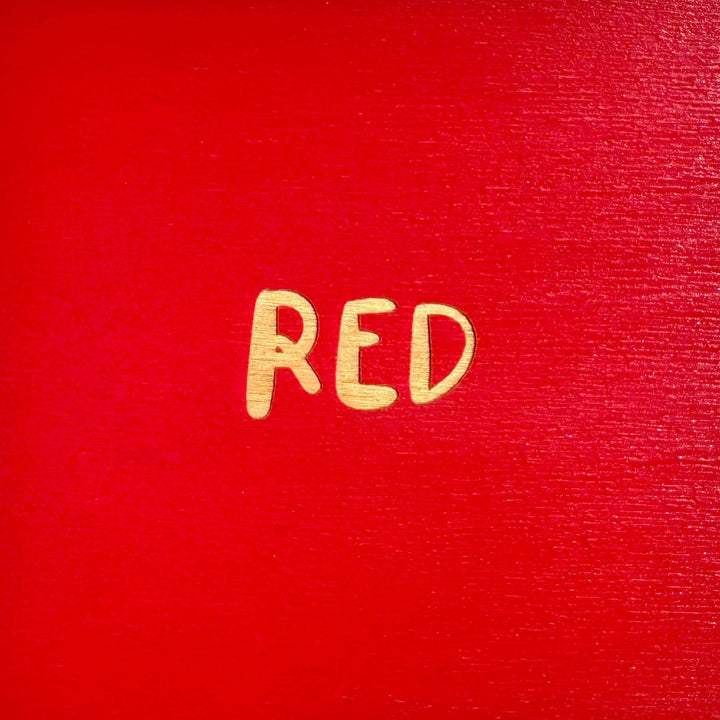 A red square to show the color of the red keychain. The word 'red' is in the middle of the square.