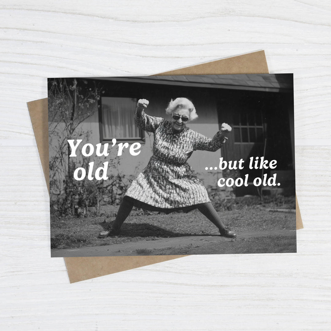 Greeting card with black and white photo of an elderly woman and humorous text on a white background.