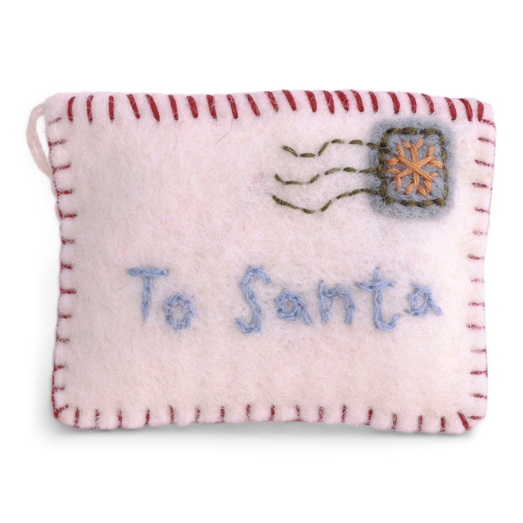 A small felt Christmas ornament shaped like a postcard, with red stitched border, blue embroidered 'To Santa' text, and a gray postage stamp with an orange snowflake on a white background.