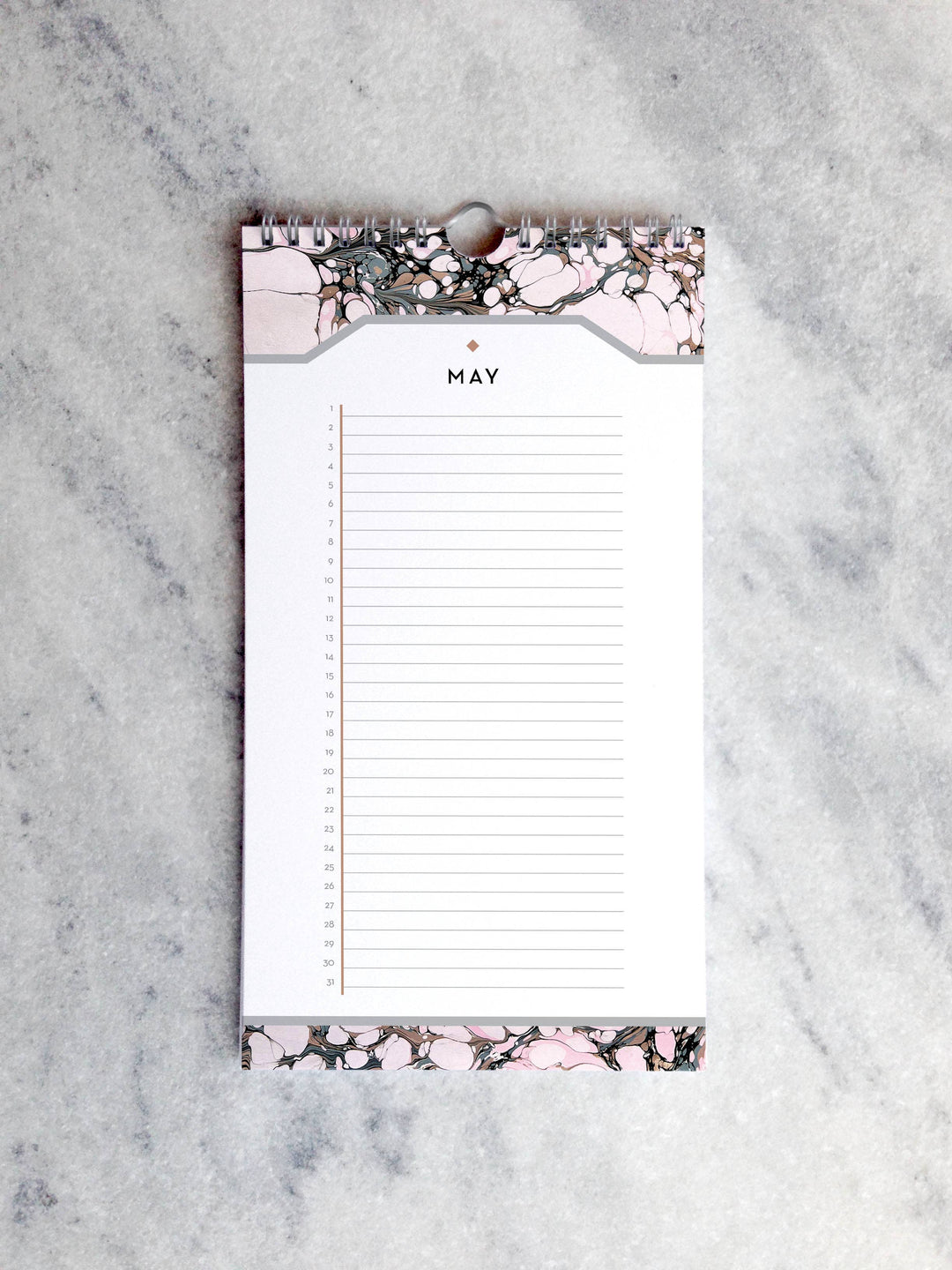 Page for May with marbled paper in shades of light pink and brown at the top and bottom. Below the month title is a line for each day of the month.
