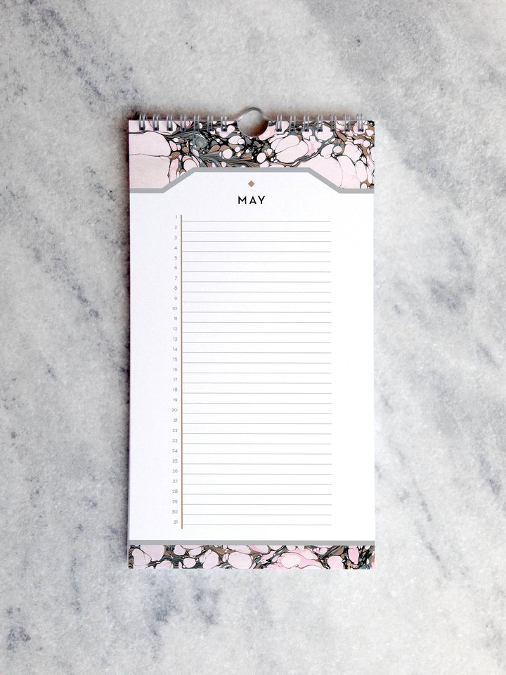 Page for May with marbled paper in shades of light pink and brown at the top and bottom. Below the month title is a line for each day of the month.
