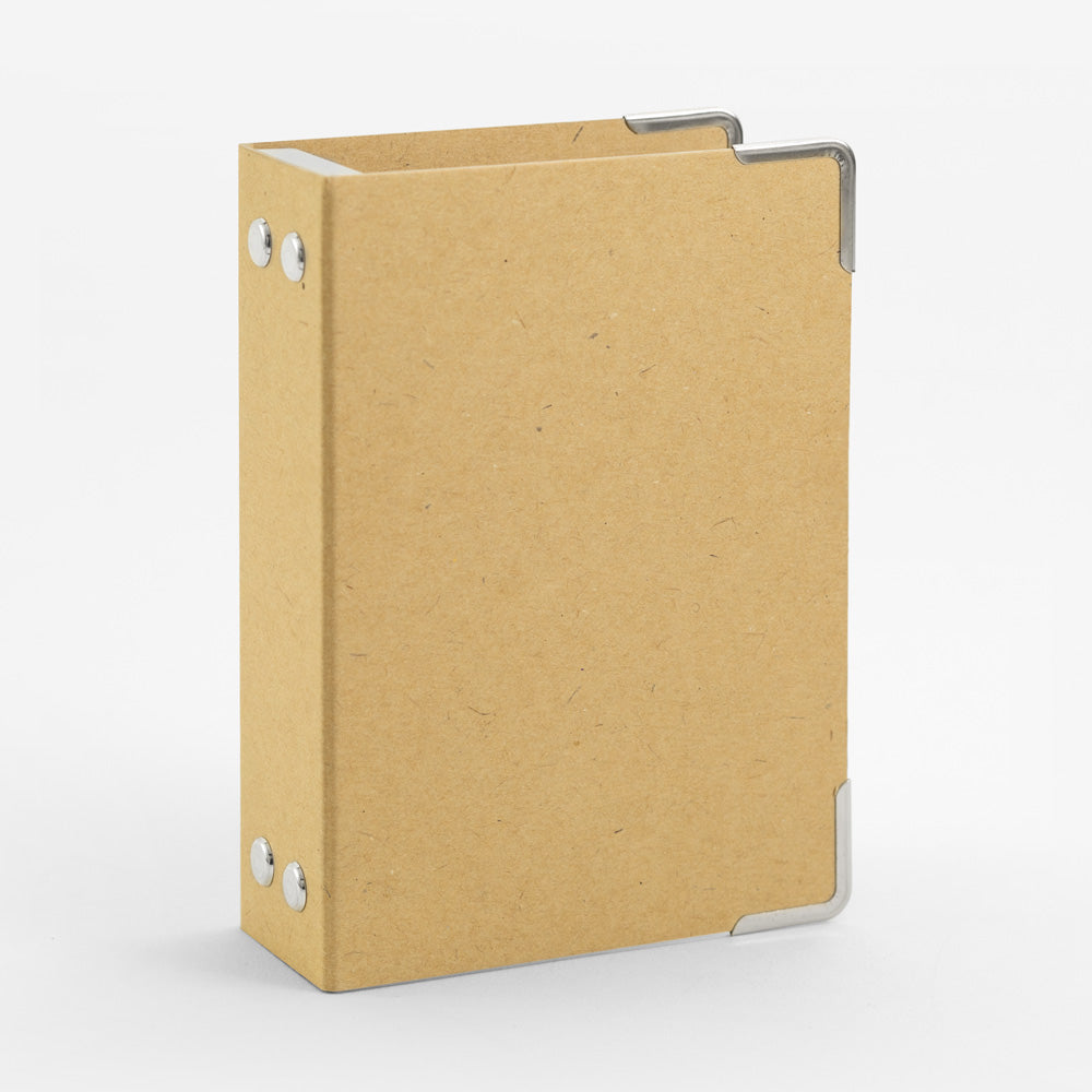 Brown cardboard binder with reinforced corners for passport-sized Traveler's inserts.