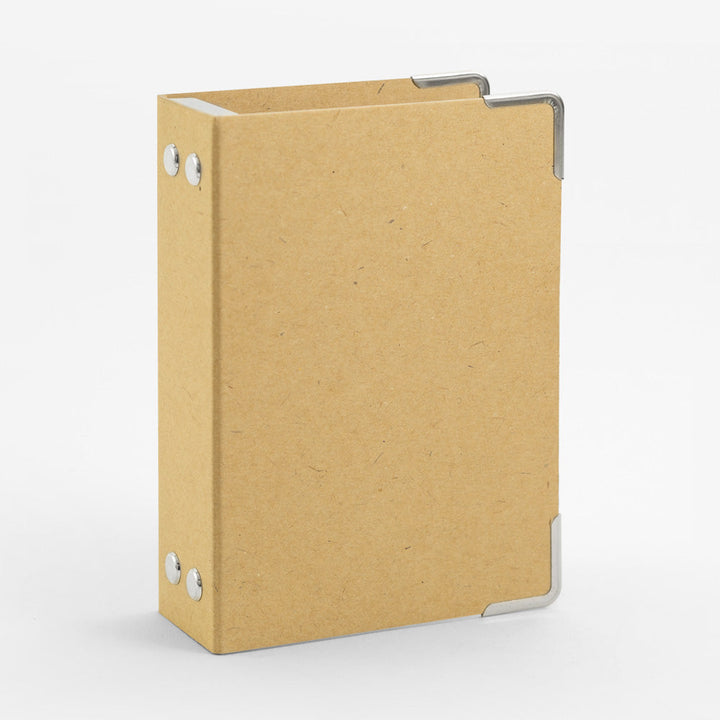 Brown cardboard binder with reinforced corners for passport-sized Traveler's inserts.