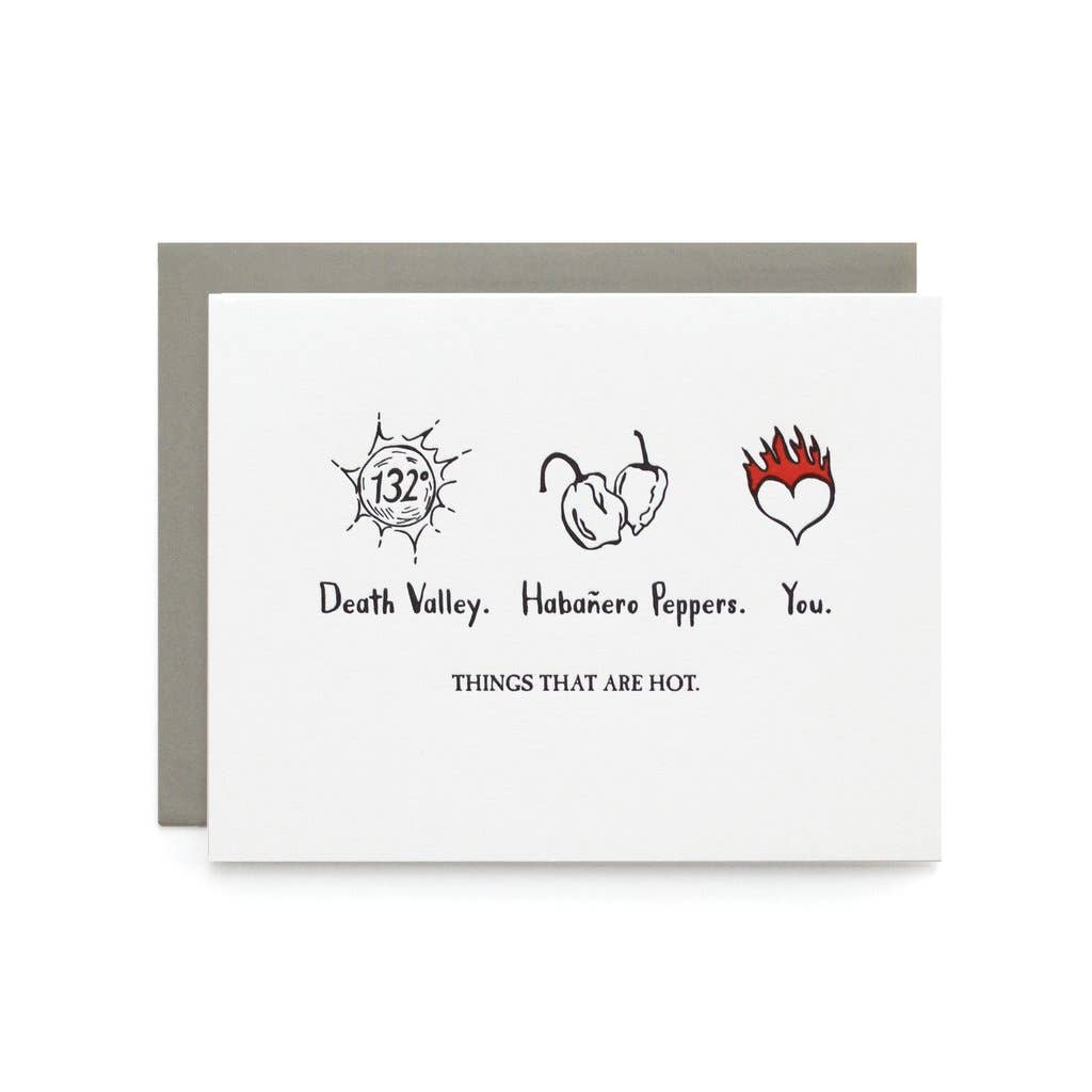 Drawings of a hot sun, two peppers, and a heart on fire over the text in black on white cardstock.