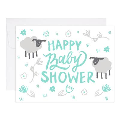 Two hand drawn sheep, with flowers and grass, and aqua text on white cardstock