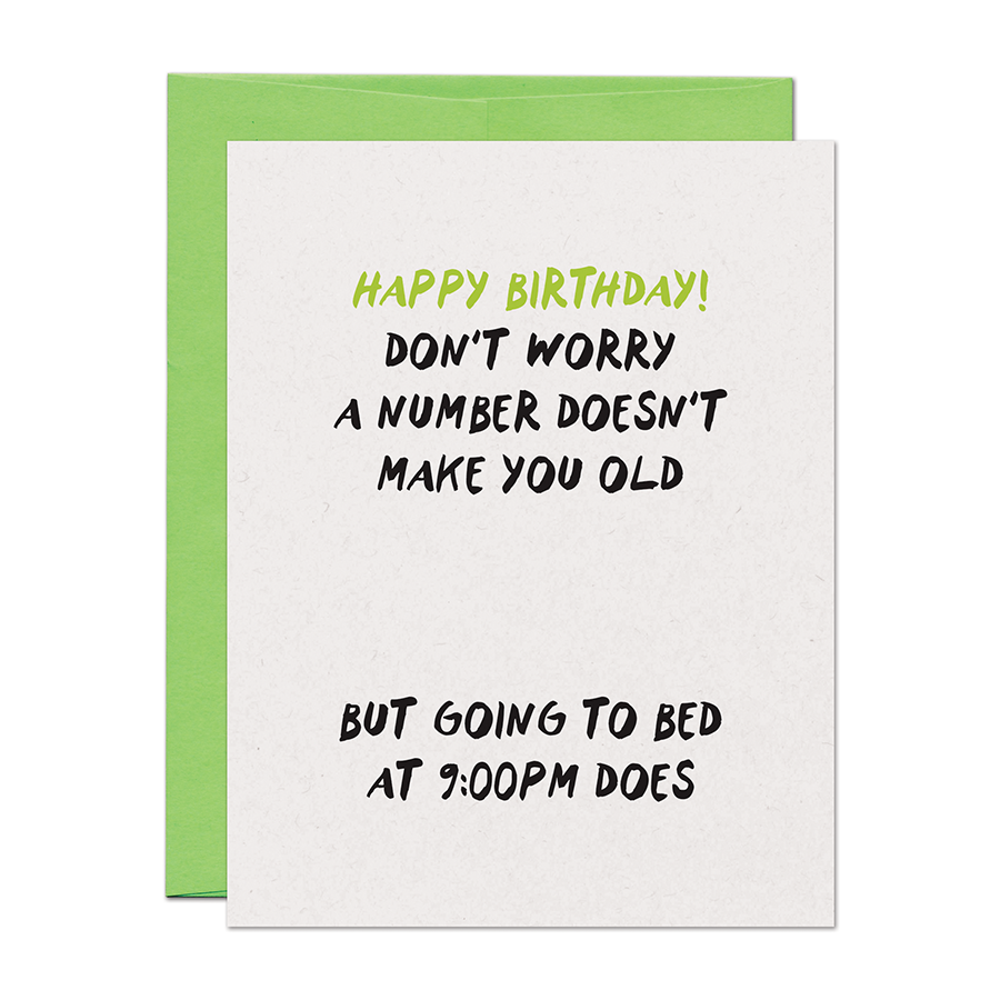 Birthday card with humorous text on a white background with green envelope.