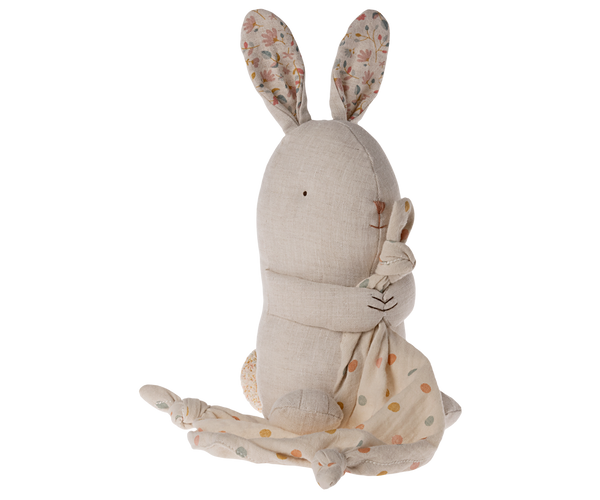 Pink bunny rabbit with patterned fabric ears, holding a polka dot blanket.