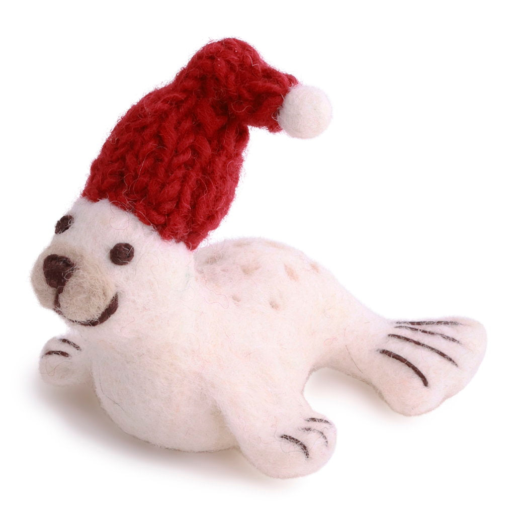 Plush seal toy wearing a red knitted Santa hat on a white background