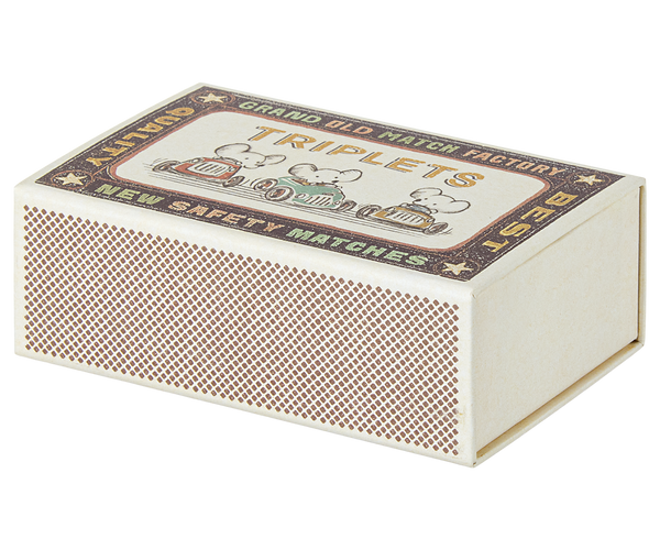 Vintage-style matchbox with decorative label.