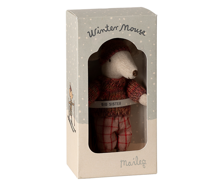 Mouse dressed in orange-pink winter clothing in box labeled "Winter Mouse Big Sister."