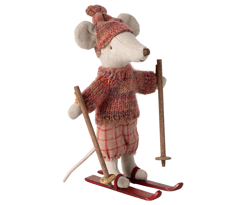 Mouse dressed in orange-pink winter clothing on skis and holding poles. 