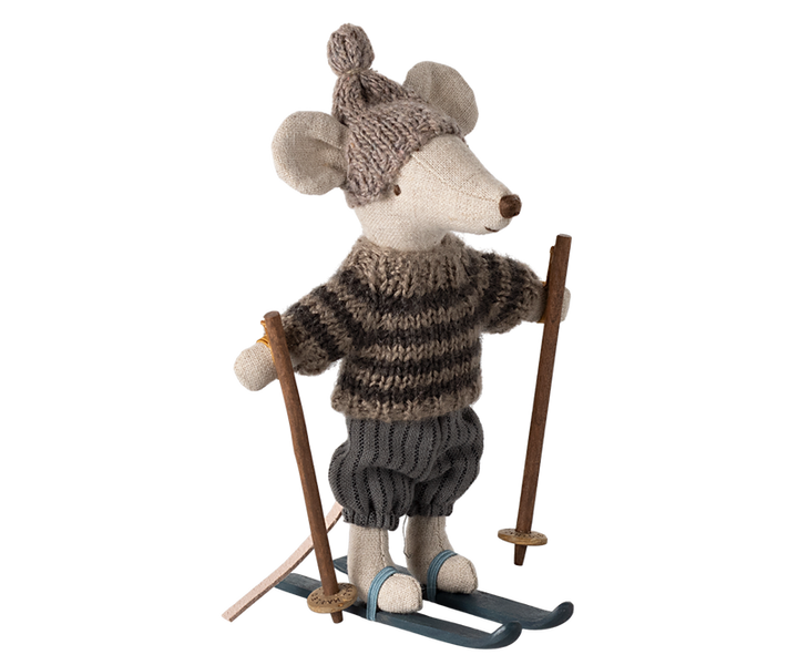 Mouse dressed in brown and tan winter clothing on skis and holding poles.