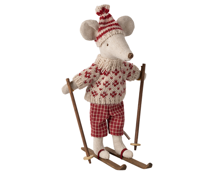 Mouse dressed in red and beige winter clothing on skis and holding poles.