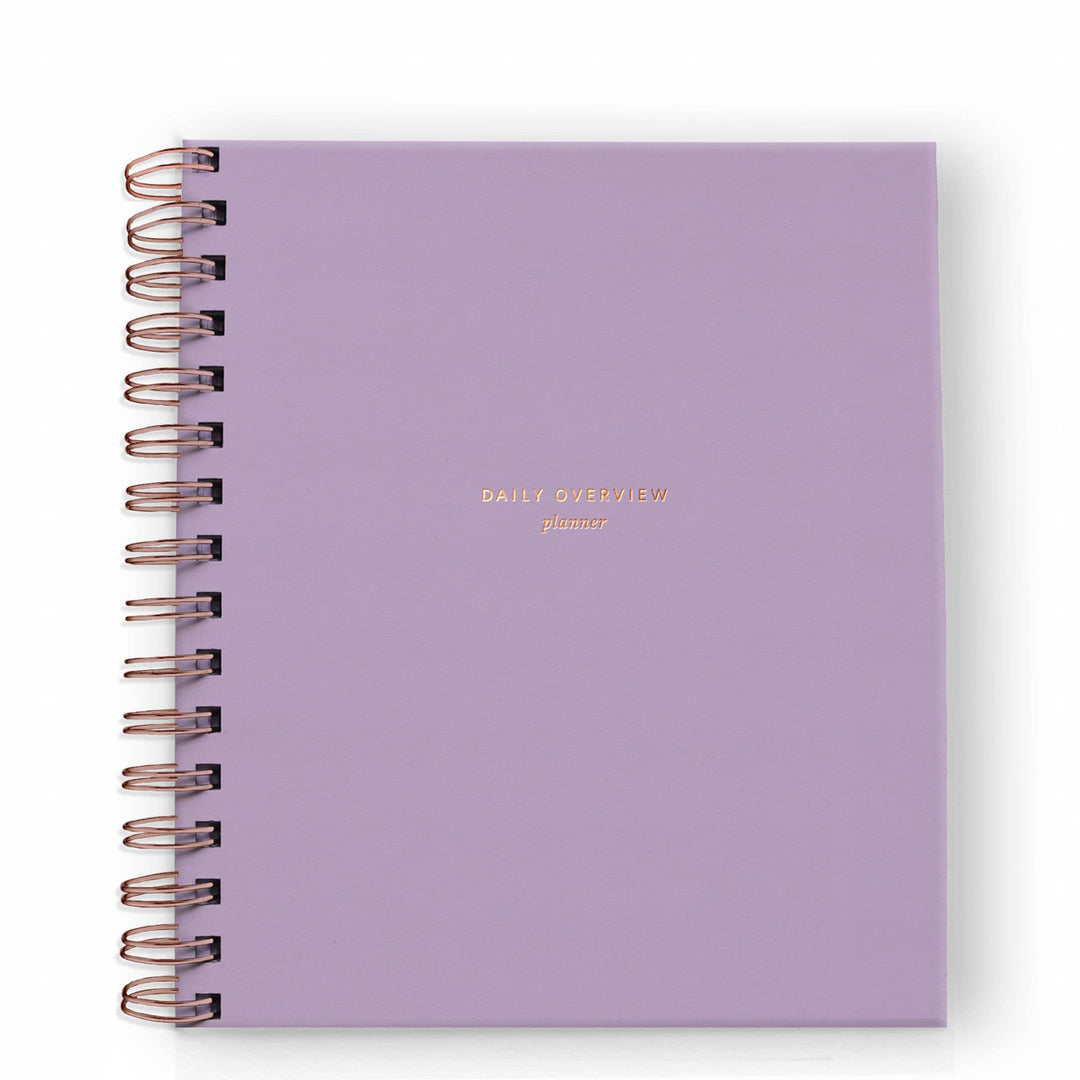 Cover of daily planner in lavender with gold spiral binding on the left side.