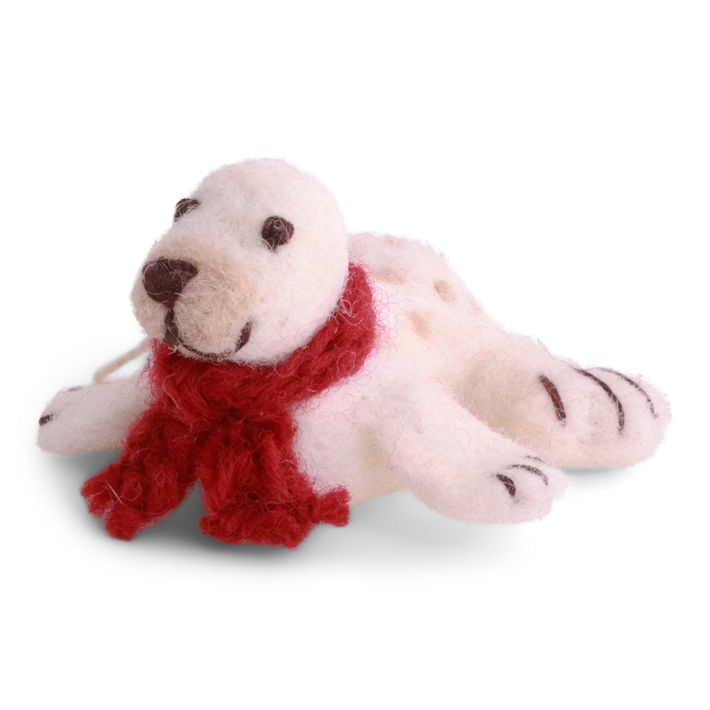 A white felt baby seal with a red knitted scarf.