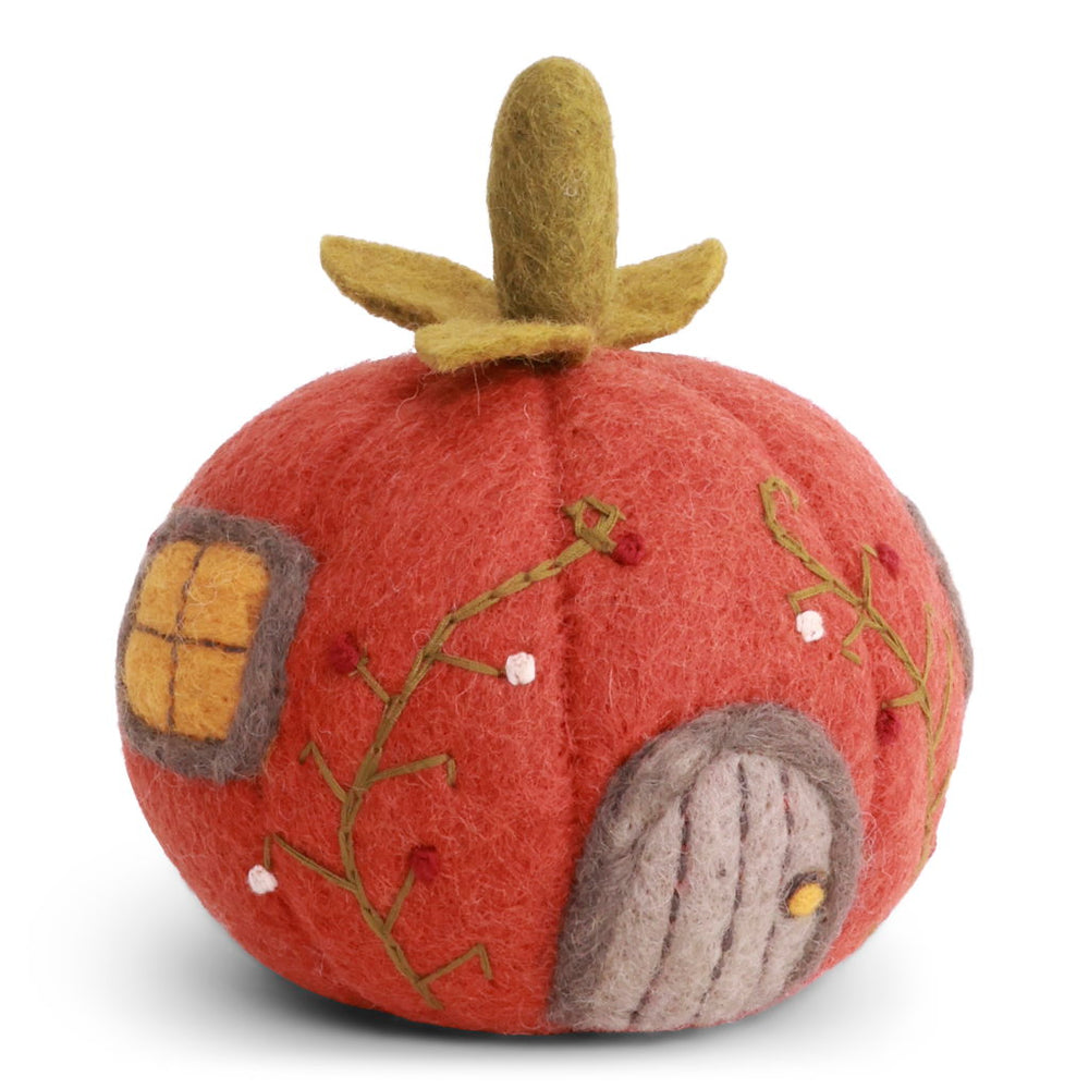 A felt pumpkin-shaped decorative house with a rusty red body, olive green stem, embroidered green vines, a gray door, and a yellow window.