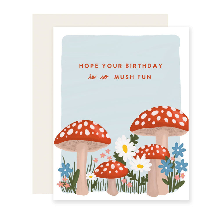 Bright mushrooms with white dots on red tops looming large amongst flowers. Red block letters on a blue background.