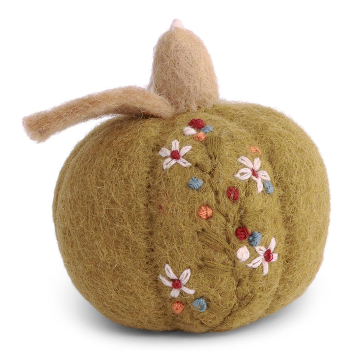 A handmade felted wool pumpkin decoration in a muted olive green color, featuring a textured fuzzy body, a tan felted stem, and embroidered white flowers with red and blue centers.