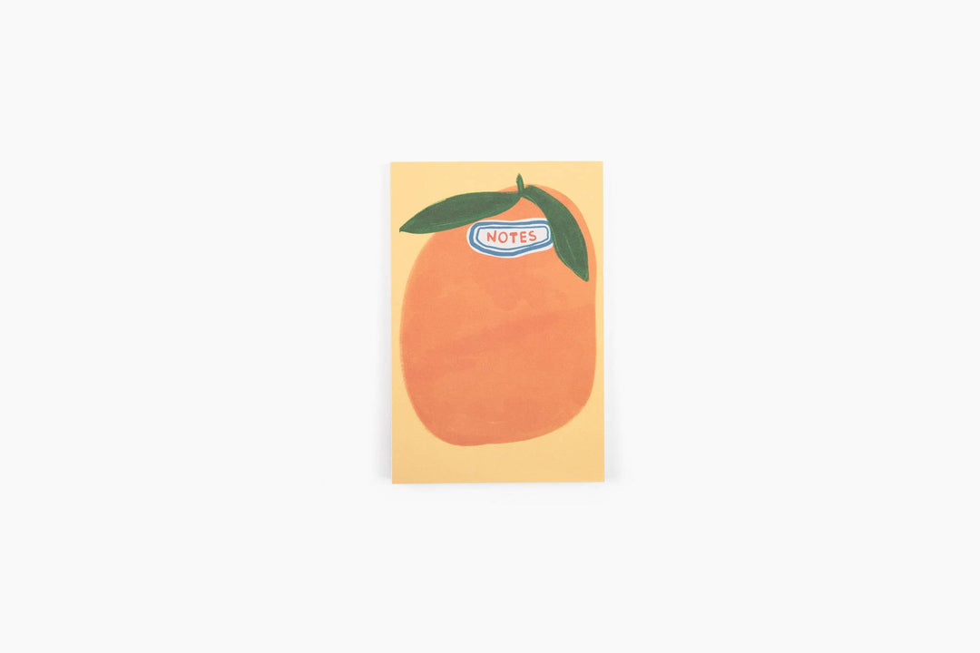 Sticker with an orange and two leaves on a yellow background.