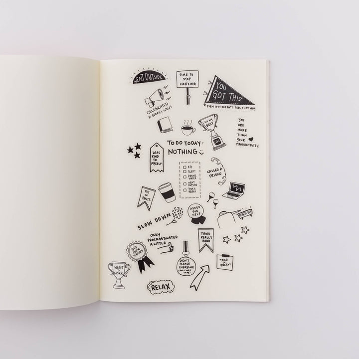 Open notebook with stickers placed on a page.