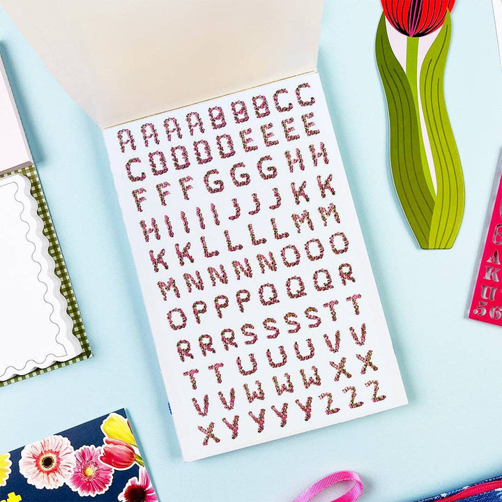 Sheet of cursive capital letter stickers composed from flowers.