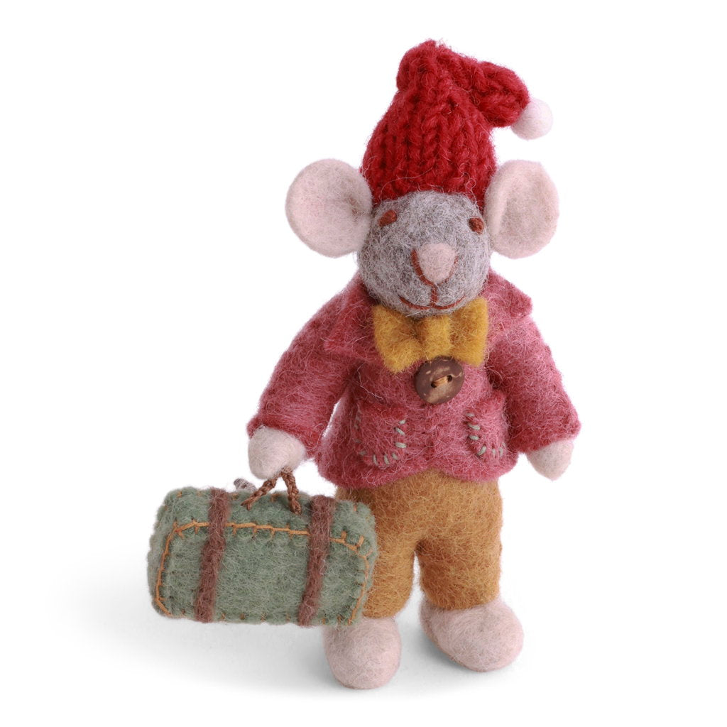 A felted wool mouse dressed in a red knit Santa knit hat, pink jacket, mustard yellow bow tie, and tan trousers and holding a small green suitcase.