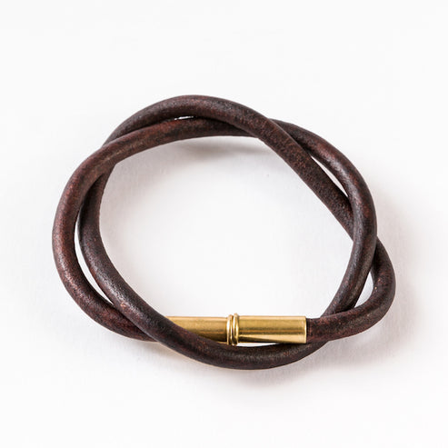 Brown double-wrapped smooth leather bracelet with a brass clasp.