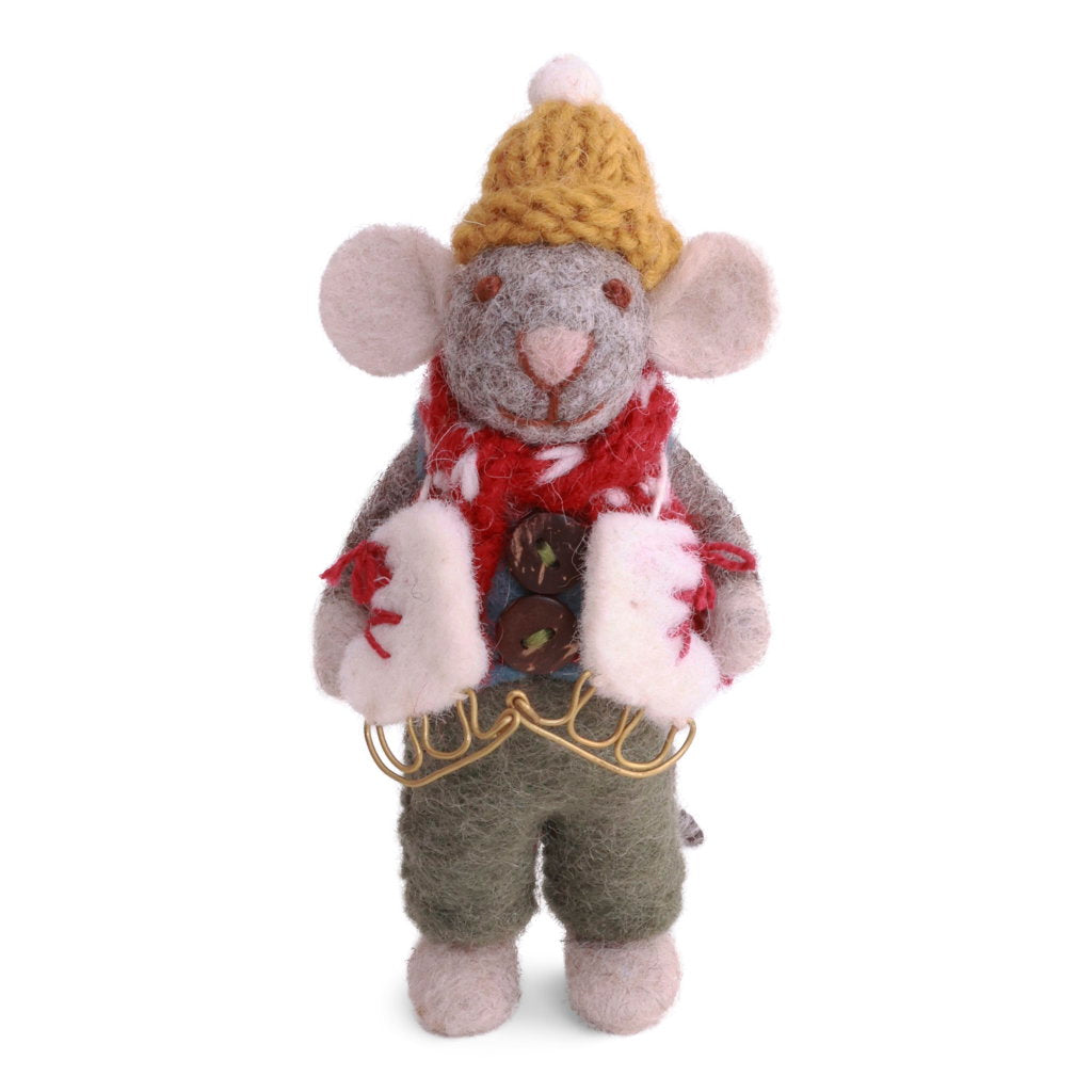 A felted wool mouse dressed in a yellow knit hat, red scarf, green pants, and with a pair of white ice skates with red laces draped round its neck.