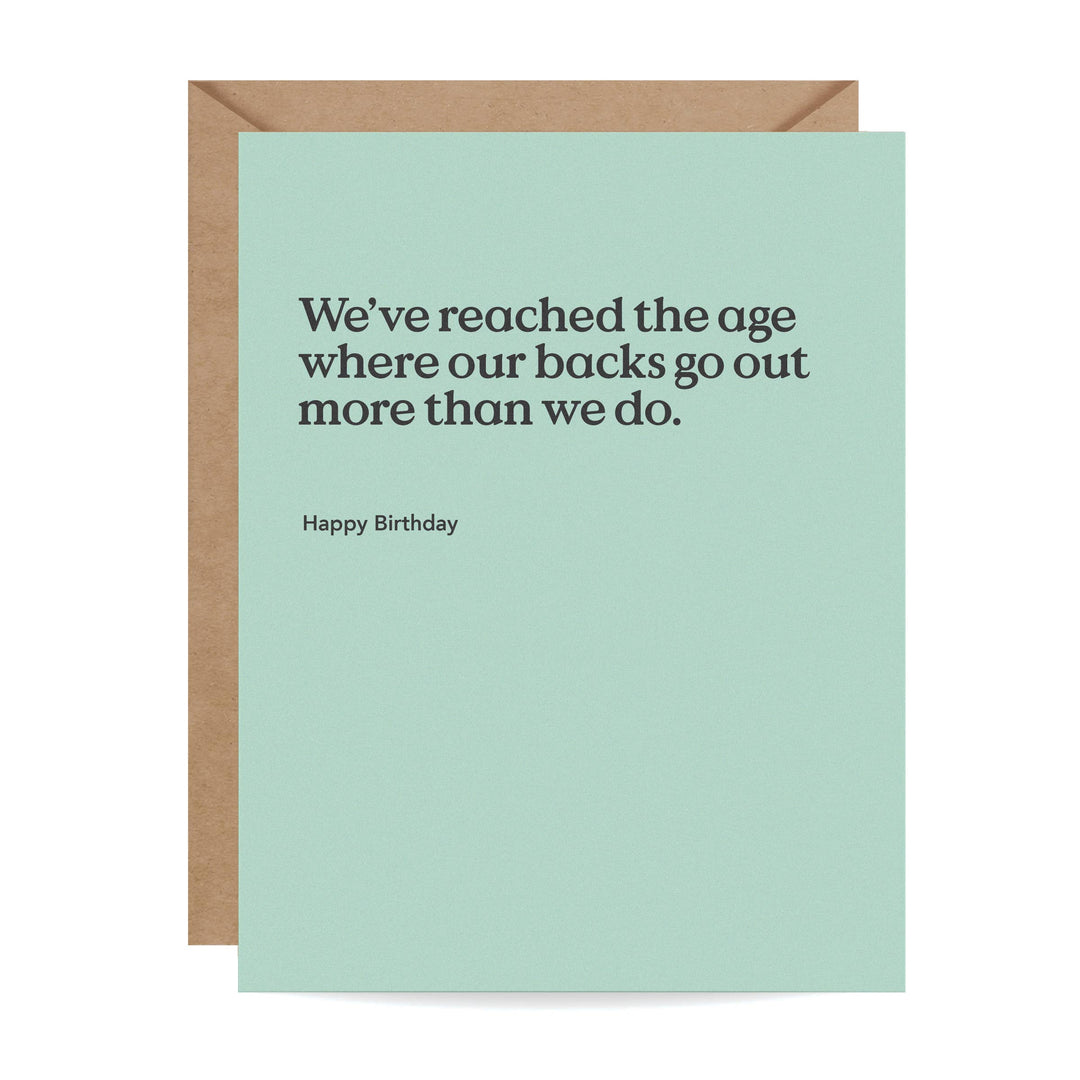Front of light blue birthday card with humorous text and brown envelope.