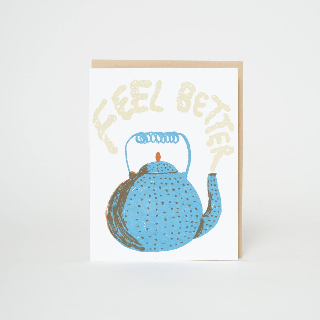 Blue teapot with brown dots and a coiled wire handle, on white cardstock with text displayed as steam from the pot.