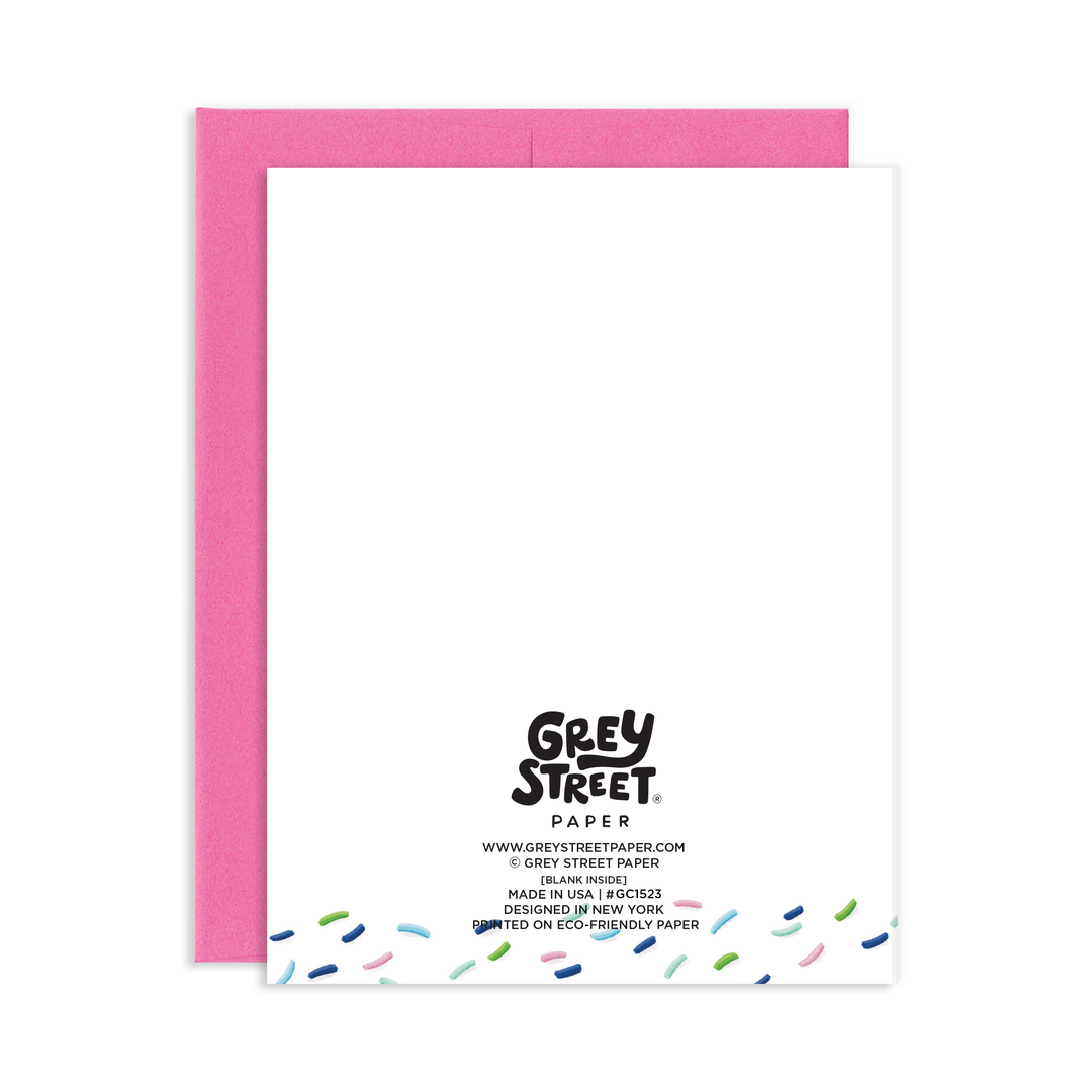 Back of card with confetti at the bottom under Grey Street info, with a pink envelope underneath.